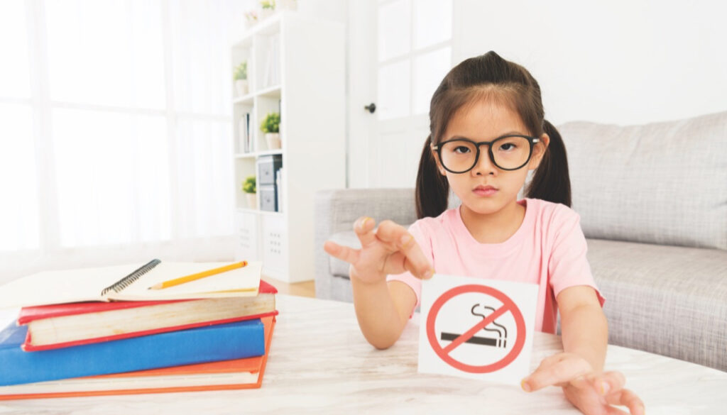 beauty girl kid showing no smoking sign to camera