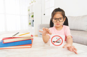 beauty girl kid showing no smoking sign to camera