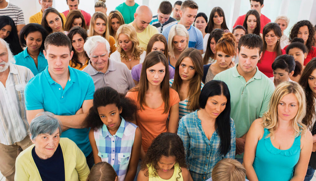 High angle view of large group of serious people standing together.