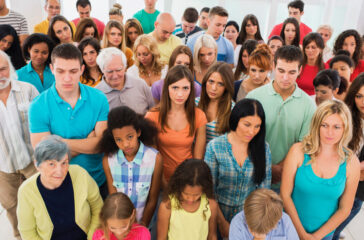 High angle view of large group of serious people standing together.