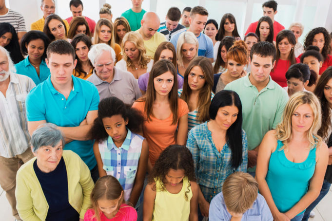 Measles: Who’s At Risk? High angle view of large group of serious people standing together.