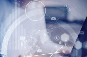 Concept of virtual interfaces,digital icons,worldwide online connections.Female hand touching black screen modern smartphone on the wooden table.Young business people using mobile devices.Blurred