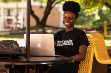 Elisabeth Petit-Bois, a Kennesaw State University software engineering student who will complete an internship at CERN this summer, poses outside of the Atrium Building on the Marietta Campus on May 14, 2019.