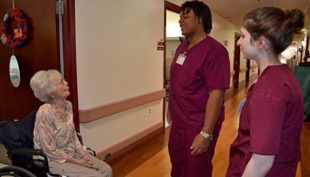 Merle Houston, a resident at A.G. Rhodes, talks with students Elijah Branche and Abby Fishman.