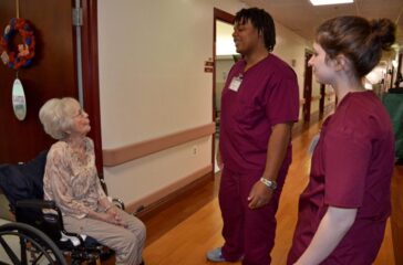 Merle Houston, a resident at A.G. Rhodes, talks with students Elijah Branche and Abby Fishman.