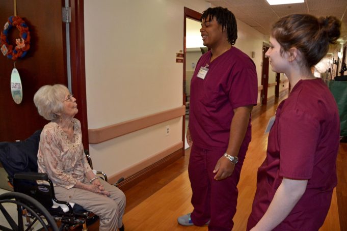 Proud Partners Merle Houston, a resident at A.G. Rhodes, talks with students Elijah Branche and Abby Fishman.