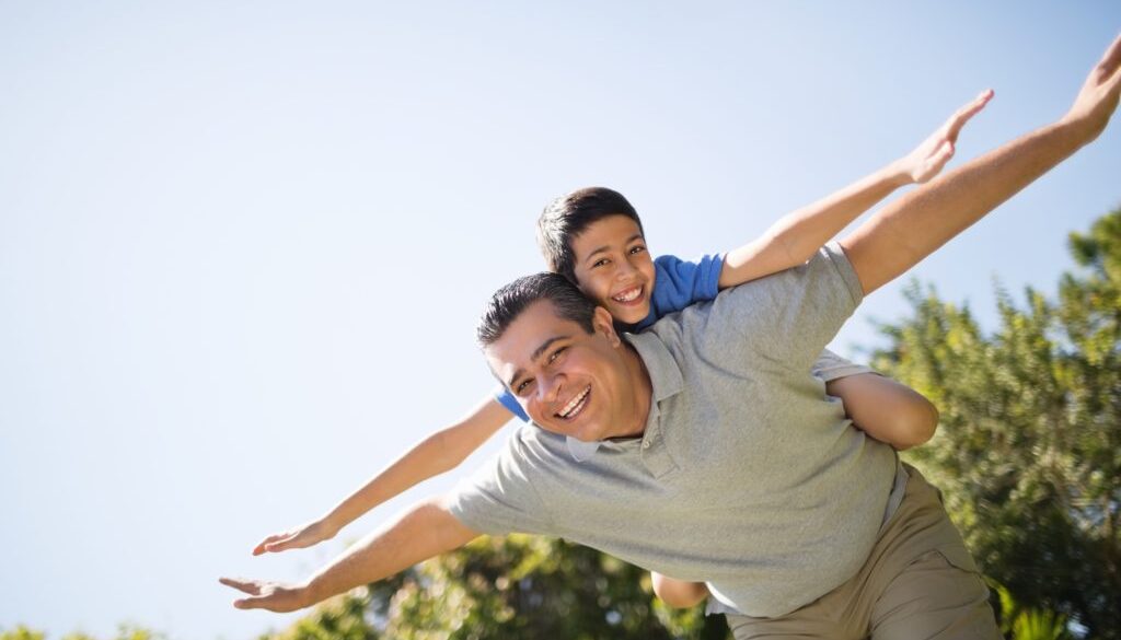 Father Giving Piggyback Ride To Son