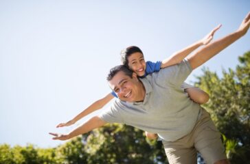 Father Giving Piggyback Ride To Son