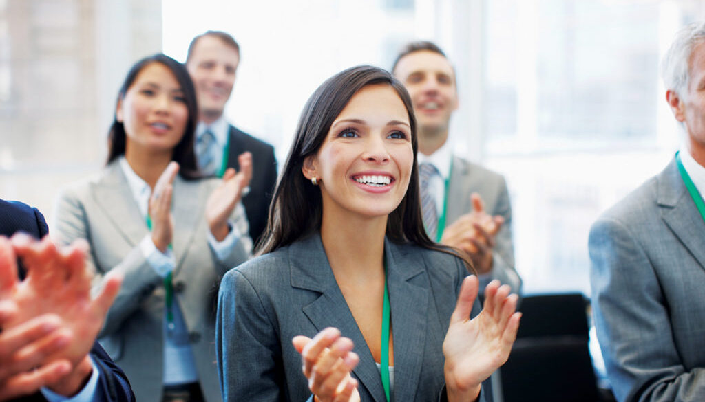 Business people clapping in seminar