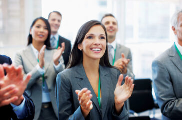 Business people clapping in seminar