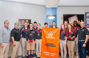 MPCS Robotics Team Wins Two State Championships MPCS carbon fiber with banner and head of school