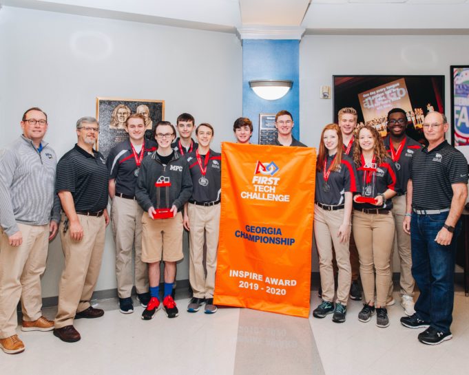 MPCS Robotics Team Wins Two State Championships MPCS carbon fiber with banner and head of school