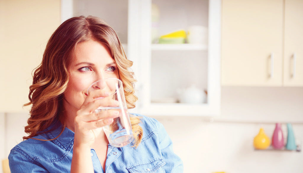 woman drinking a glass of water