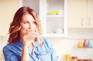 woman drinking a glass of water