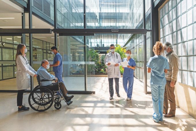 How Local Health Providers Are Making Healthcare Safe People walking in and out of the hospital - Healthcare concepts