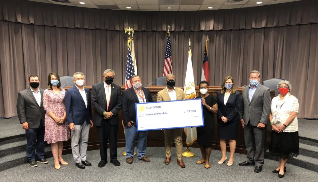 Cobb County Board of Commission members present grant funds to local business House of Heralds.