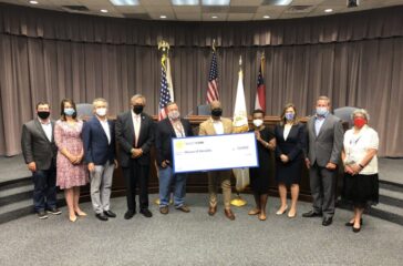 Cobb County Board of Commission members present grant funds to local business House of Heralds.