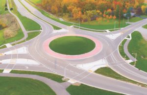 Roundabouts Aerial view of roundabout intersection at first light, with Autumn trees.