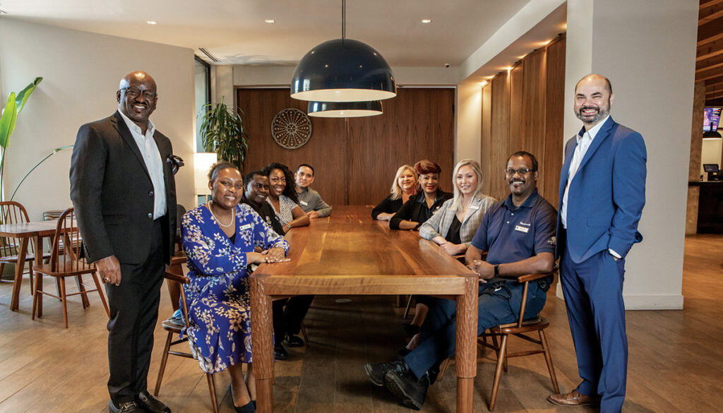 Pictured left to right going around the table: Gregory Brown, General Manager; Alicia Smith, Accounting Manager; Lamin Sarr, Executive Chef; Cerissa Stewart, Convention Services Coordinator; Omar Mendoza, Executive Housekeeper; Robin Snyder, Controller; Mai Jallow, Director of Human Resources; Wendy Jettmar, Corporate Sales Manager; Andre Hill, Chief Engineer; and Paul Woodley, Director of Sales.