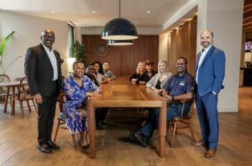 Pictured left to right going around the table: Gregory Brown, General Manager; Alicia Smith, Accounting Manager; Lamin Sarr, Executive Chef; Cerissa Stewart, Convention Services Coordinator; Omar Mendoza, Executive Housekeeper; Robin Snyder, Controller; Mai Jallow, Director of Human Resources; Wendy Jettmar, Corporate Sales Manager; Andre Hill, Chief Engineer; and Paul Woodley, Director of Sales.