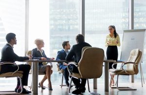 It’s All In The Presentation Asian coach presenter giving corporate business presentation at office board multi-ethnic team meeting, chinese manager speaking to diverse sales group training presenting new project on whiteboard