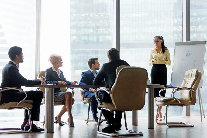 It’s All In The Presentation Asian coach presenter giving corporate business presentation at office board multi-ethnic team meeting, chinese manager speaking to diverse sales group training presenting new project on whiteboard