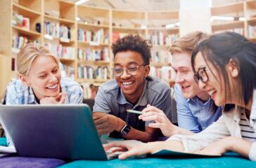 Students watching curious video on laptop