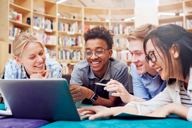 Students watching curious video on laptop