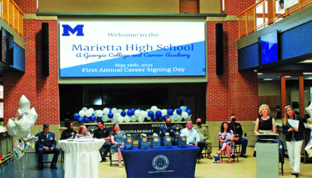 Board members, business partners, and military representatives on Career Signing stage in J Hall (new building at MHS).