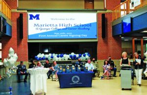 Prepared For Success Board members, business partners, and military representatives on Career Signing stage in J Hall (new building at MHS).