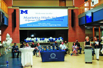 Board members, business partners, and military representatives on Career Signing stage in J Hall (new building at MHS).