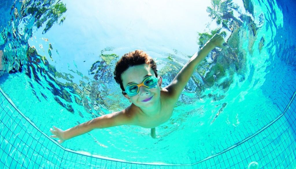 Underwater Young Boy Fun in the Swimming Pool with Goggles