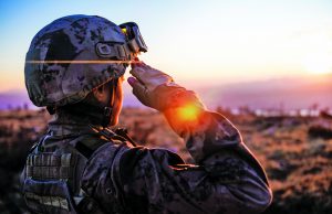 Honoring Military Veterans Female Army Solider Saluting against sunset sky