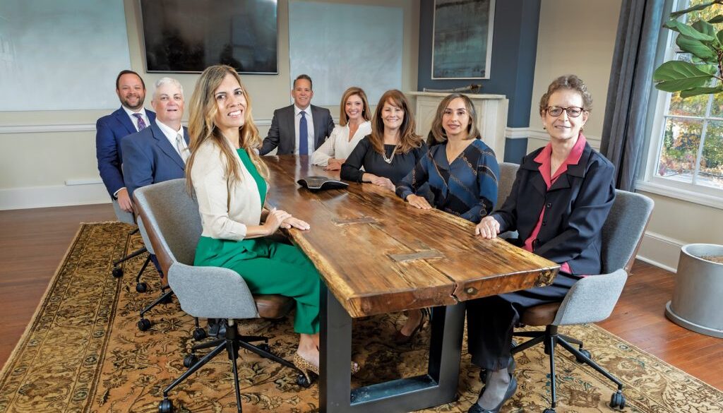 The Wickham team, pictured left to right and front to back: Iris Turner, Agent; Michael Beecher, Advisor/Agent; Jeremy Cronemeyer, Operations Manager; Debbie Alfonsi, Admin/Customer Support; Siley Vaia, Ops Mgr/Commercial Customer Support; Susanne Wickham-Cook, Personal/Commercial Lines Agent; Stacey Scott, Marketing and Client Relations; and Graham Wickham, President/CEO.