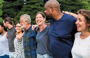 Getting With The Program Cheerful diverse people together in the park