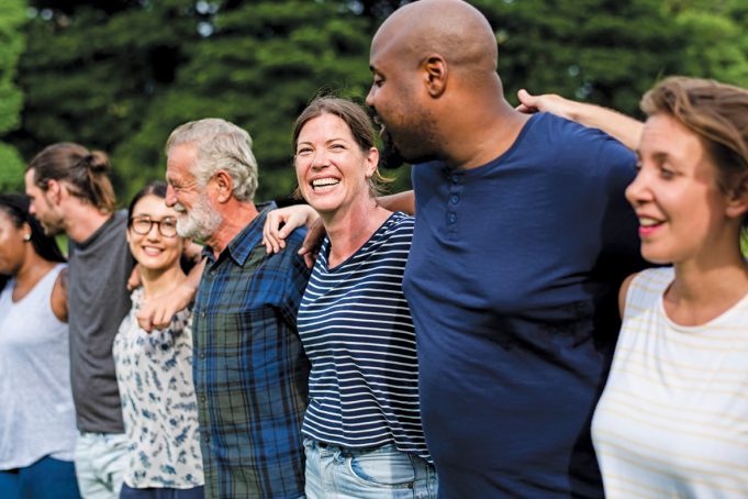 Getting With The Program Cheerful diverse people together in the park