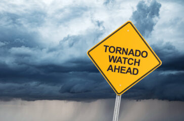 road sign that reads "tornado watch ahead."