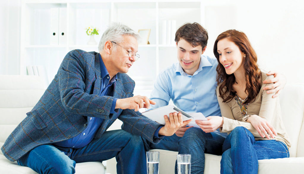 Young Couple Meeting With Senior Financial Advisor presenting new bank offers and investments on digital tablet PC. Senior Financial Advisor pointing with hand to some new offers.