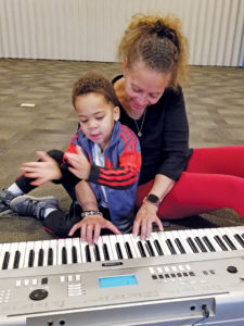 Mother playing music with toddler