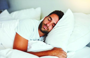 Sleep Hygiene Cropped shot of a handsome young man sleeping comfortably in his bed at home