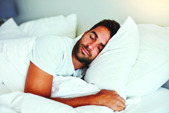 Sleep Hygiene Cropped shot of a handsome young man sleeping comfortably in his bed at home