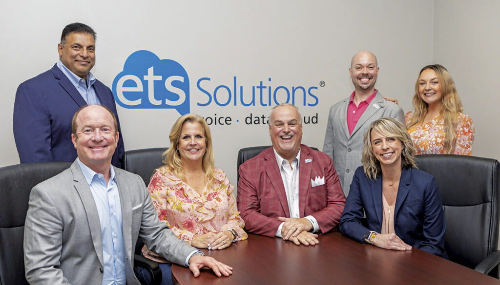 Pictured left to right: Managing Partner Thomas Collie III (seated), Client Experience Specialist Sal Thomas, Vice President Amy Russell, President Mike Russell, Technology Consultant Adam Clark, Client Development Manager Emily Snyder, and Strategic Advisor Kylah King (seated).
