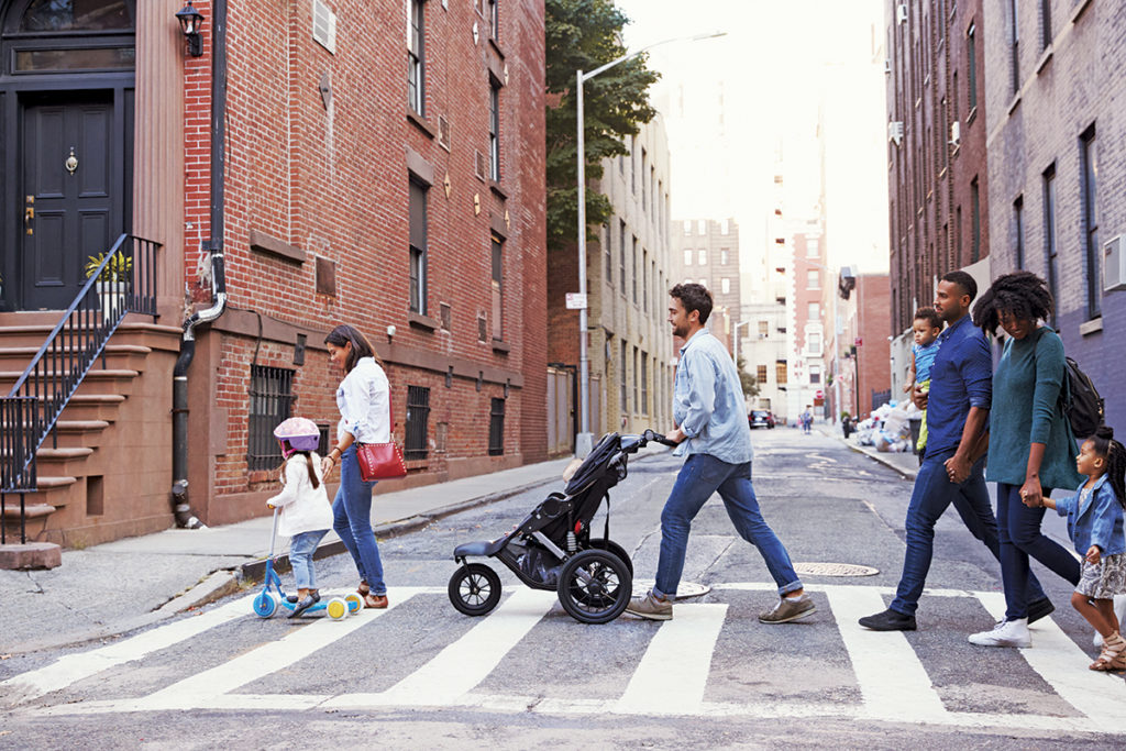 Two families with daughters crossing road