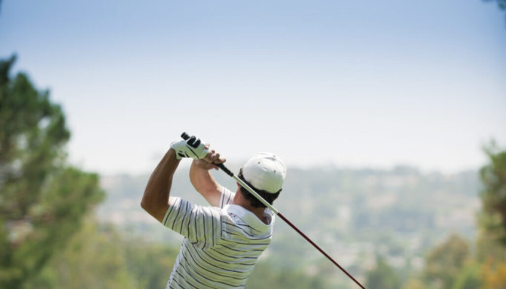 A golfer at the end of his golf swing.