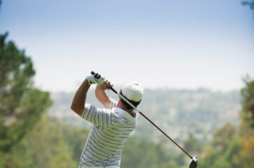 A golfer at the end of his golf swing.