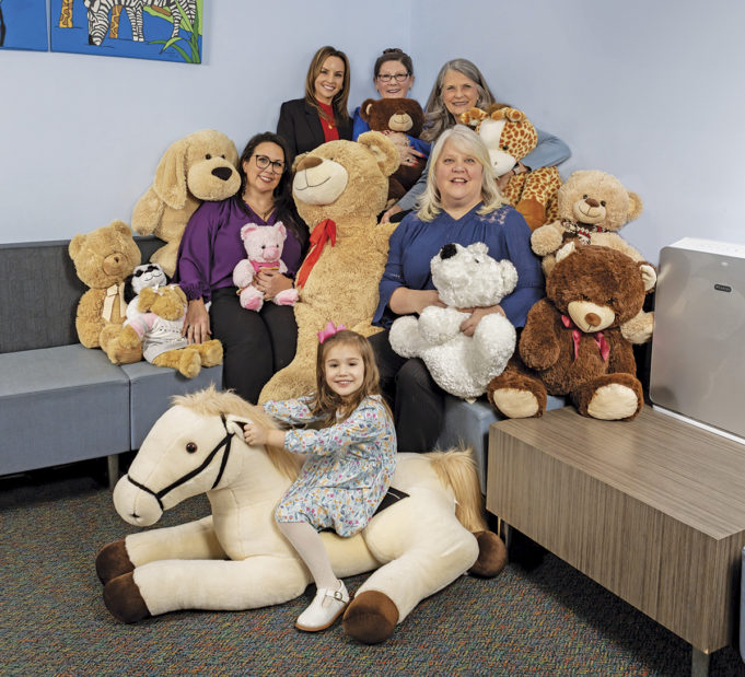 The Who, What, and Why Behind SafePath Children’s Advocacy Center Pictured L-R from the top: Claire Kirkland, LCSW, Director of Intervention Services; SafePath CEO Jinger Robins; Pam Martin, Director of Finance; Tiffany Webb, Director of Services; and Gail Garland, Director of Advocacy. The girl is not a client.
