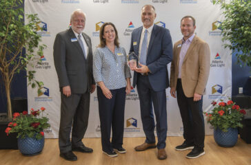 Yancey Brothers, 2024 SPARK Workforce Industry Partner of the Year. Shown here (L-R), are Dr. Ron Newcomb, Jennifer Kozel, Jim Larson (Yancey Brothers), and Board of Trustees Chair Rick Kollhoff.