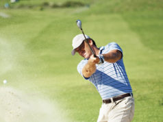 Golf Is A Win-Win! Professional golf player chipping the ball from the sand bunker