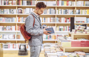 A Novel Approach To My Mornings Man looking through a book in a bookstore