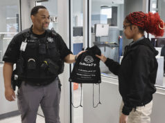 Breaking Barriers Student receives a KultureCity sensory bag from deputy.